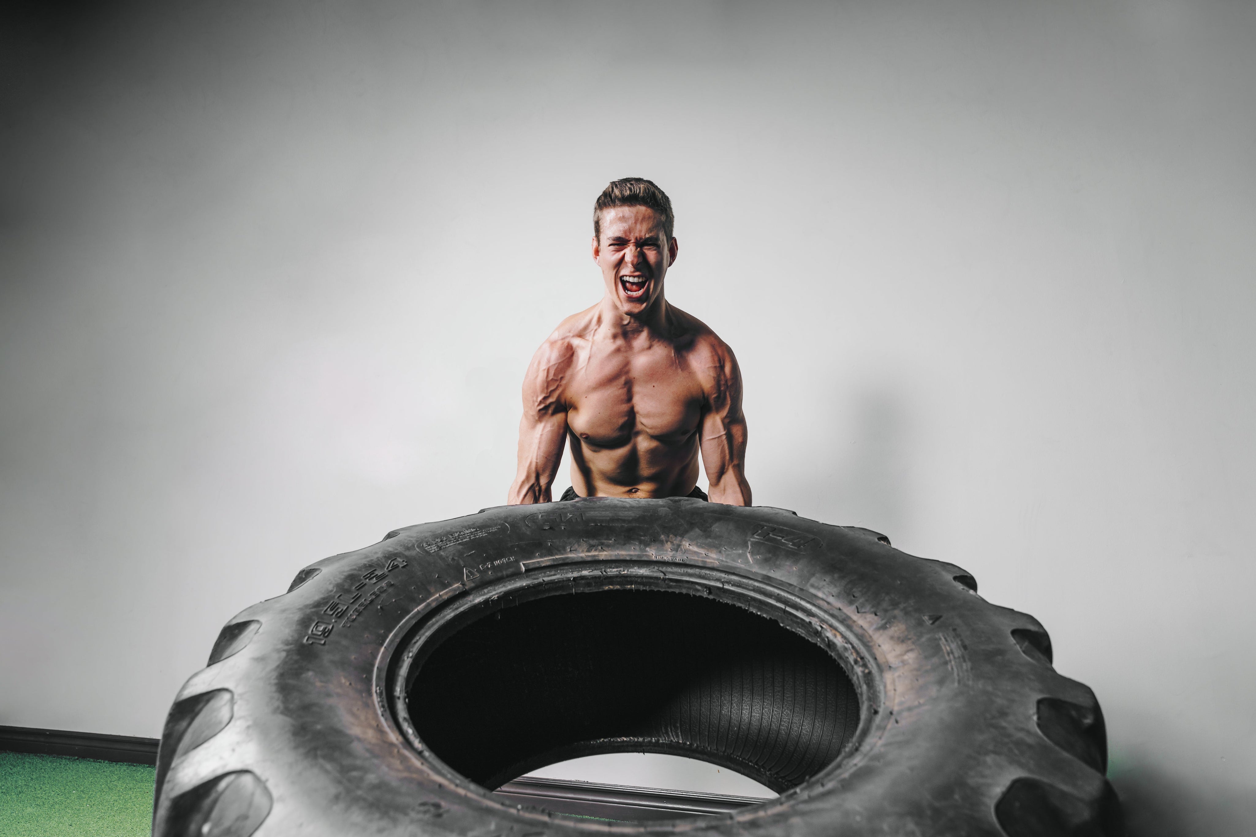 Man lifting huge tire 